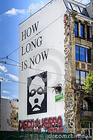 How long is now graffiti on a building wall in Berlin Editorial Stock Photo