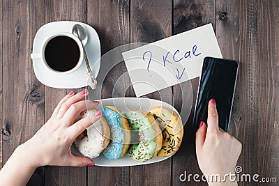 How much calories in sweet donuts, woman hold note with question Stock Photo