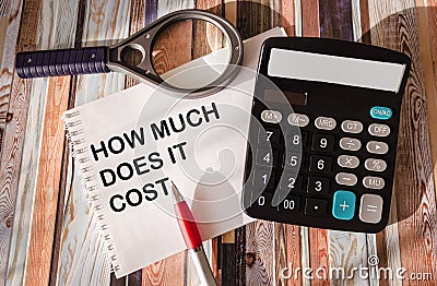 How much does it cost, write on notepad and vintage table with calculator Stock Photo