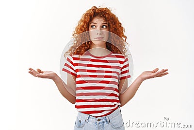 How should I know. Ignorant sassy redhead curly-haired good-looking woman shrugging perplexed look aside lying hands Stock Photo