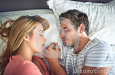 How soulmates sleep. a peaceful young couple sleeping face to face with each other in bed. Stock Photo