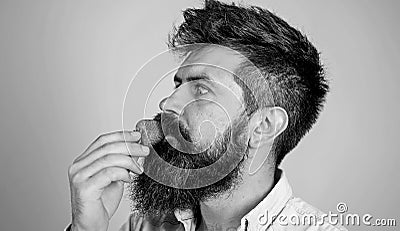 That is how tastes summer. Strawberry healthy snack. Man handsome hipster with long beard eating strawberry. Berries Stock Photo