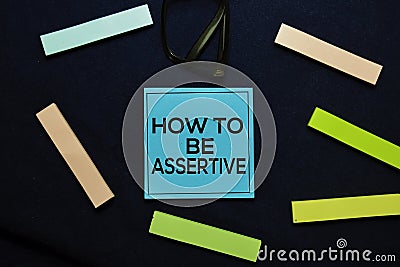 How To Be Assertive text on sticky notes isolated on office desk. Stock Photo