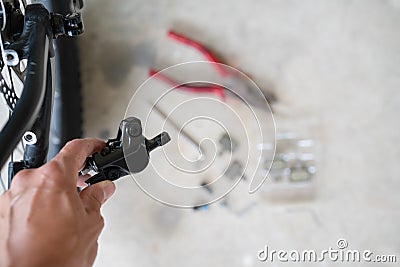 How to maintenance a mtb hydraulic disc brake caliper : Repairman holding a Hydraulic rear disc brake caliper on a mountain bike. Stock Photo