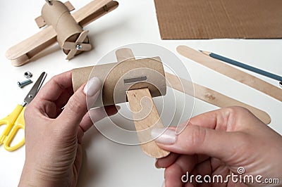 How to make airplane. Hand made toy,zero waste from toilet paper roll and popsicle sticks. For kids and parents. Step 4, first try Stock Photo