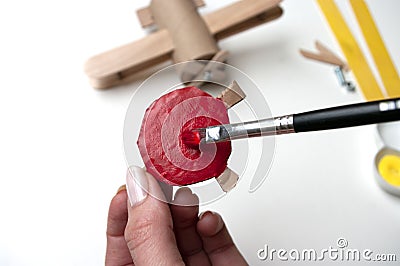 How to make airplane. Hand made toy,zero waste from toilet paper roll and popsicle sticks. For kids and parents. Step 16 paint Stock Photo