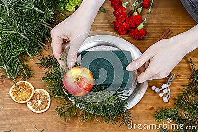How to make christmas floral arrangement with carnations, chrysanthemum santini flowers and fir Stock Photo
