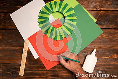 How to make christmas wreath from color paper with children. Step by step instructions. Handmade DIY new year holiday decoration p Stock Photo