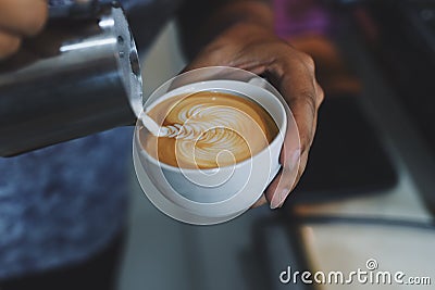 How to make coffee latte art by barista in vintage color tone Stock Photo