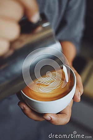 How to make coffee latte art by barista in vintage color tone Stock Photo