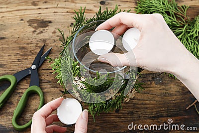 How to make decorative christmas jar for candles with thuja twigs wreath and wooden stars Stock Photo