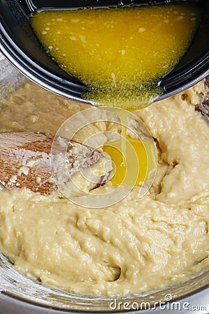 How to make yeast dough - step by step: add melted butter Stock Photo