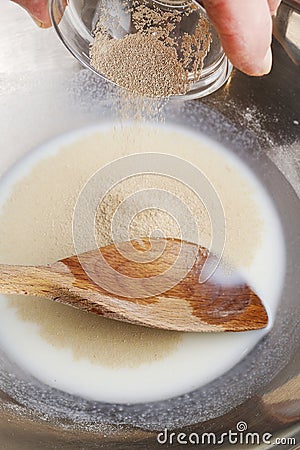 How to make yeast dough - step by step: mix dry yeast with milk Stock Photo