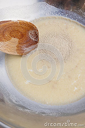How to make yeast dough - step by step: mix dry yeast with milk Stock Photo