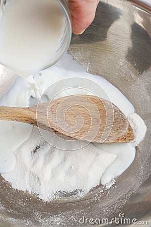 How to make yeast dough - step by step: mix milk with sugar Stock Photo