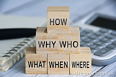 How, why, who, what, when and where text on wooden blocks with calculator, pen and notebook background. Solution concept Stock Photo