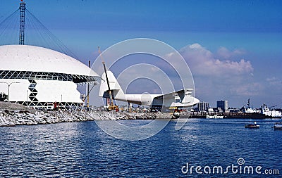 Howard Hughes Spruce Goose Hercules HK-1 N37602 CN 1 H-4 being moved into a dome next to the HMS Queen Mary at the Port of Long Editorial Stock Photo
