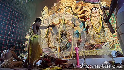 Hindu Priest worshipping Goddess Durga with chamor, fly whisk fan Editorial Stock Photo