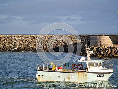 Howth Lighthouse. Fishing boat on Irish sea Editorial Stock Photo