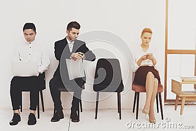 A man in a suit looks at his watch while waiting. Stock Photo