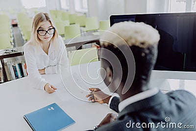 HR manager interviewing young woman in modern office Stock Photo