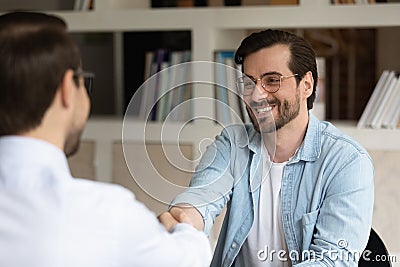 Hr manager shaking smiling man hand, congratulating successful candidate Stock Photo