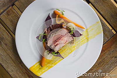 72 hr rare beef short rib with carrots, turnips, beets & pickled mustard seeds Stock Photo