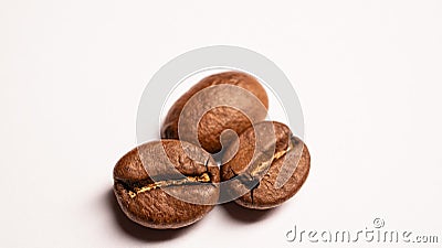 Hree coffee beans on a white table Stock Photo
