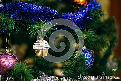 Ð¡hristmas ball in shape of muffin on Christmas tree. Stock Photo