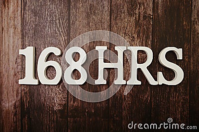 168 HRS Number of hours in a week with space copy on wooden background Stock Photo