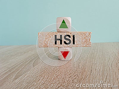 HSI price symbol. A brick block with arrow symbolizing that Hang seng index price are going down or up Editorial Stock Photo