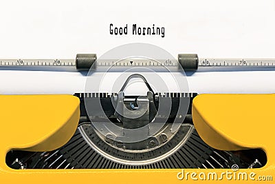 Good Morning typed on Yellow typewriter. Stock Photo