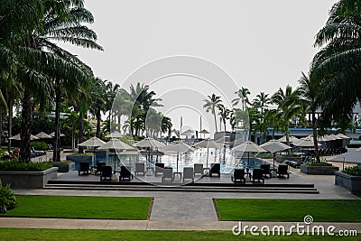 Resturant with tables, chairs and white umbrella waiting for customers in high season on the beach, Thailand. Stock Photo