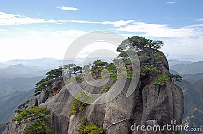 Huangshan Mountain in Anhui Province, China. View of a rocky outcrop surmounted by pine trees on the path to Lotus Peak Stock Photo