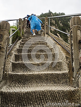 Huashan mountain: tourists climbing up the stairs trail to the North Peak - Xian, Shaaxi Province, China Editorial Stock Photo