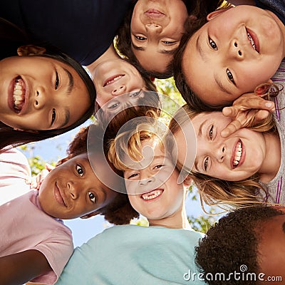 A huddle of school kids looking down at camera, close up Stock Photo