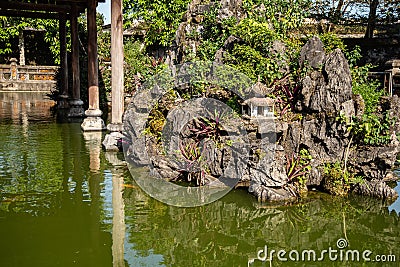 Hue, Vietnam, the imperial citadel. View of a palace water and rock garden with bonsai trees. Stock Photo