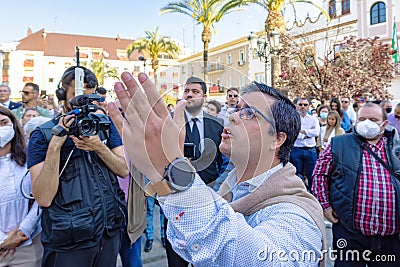 Huelva, Spain - April 15, 2022: A man is singing a saeta in front of the image of the virgin that comes out in procession of Editorial Stock Photo