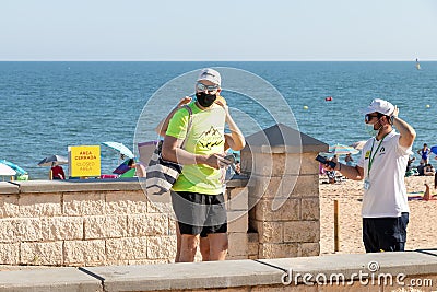 Huelva, Spain - July 4, 2020: Beach safety guard of Junta de Andalucia is controlling the access to Islantilla beach for Editorial Stock Photo