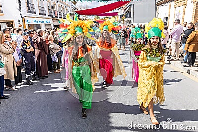 Beautiful exotic young girls, dressing colorful period costumes, in the parade of Medieval Editorial Stock Photo