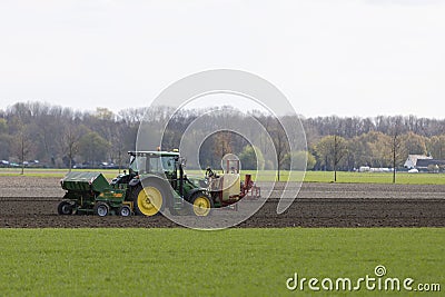 Huerth, NRW, Germany, 04 17 2021, tractor with seeding machine on a field Stock Photo