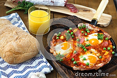 Huevos a la Flamenca or Flamenco Eggs. Eggs poached in tomato sauce. Stock Photo