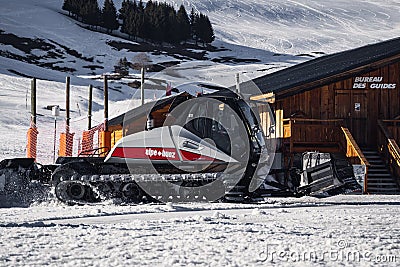 Snowcat, ratrack PistenBully - machine for snow preparation while working in Alpe D'huez Editorial Stock Photo