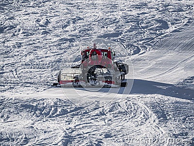 Snowcat, ratrack PistenBully - machine for snow preparation while working in Alpe D'huez Editorial Stock Photo