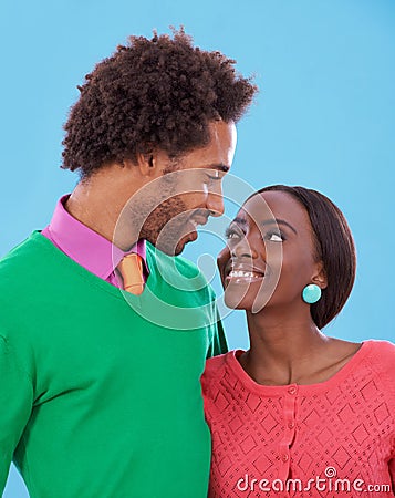 Hug, love and black couple with marriage, romance and bonding together on a blue studio background. Relationship Stock Photo