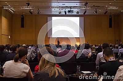 Huge audience looking at the screen with chemical structure and listening to the scientifc presentation Editorial Stock Photo
