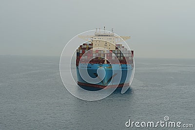 Huge blue container vessel from shipping company Maersk Lines anchored at calm sea near to port of Koper. Editorial Stock Photo