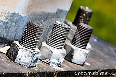 Huge bolts and nuts together in a flange fastening a giant pole Stock Photo