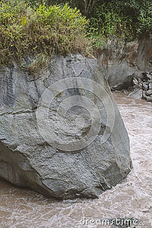 Huge boulder in water Stock Photo