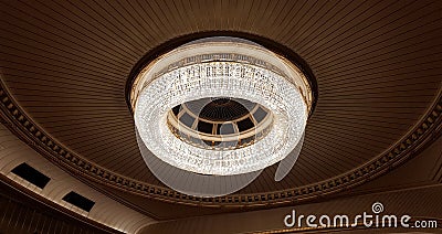 A huge chandelier hangs from the ceiling. Stock Photo